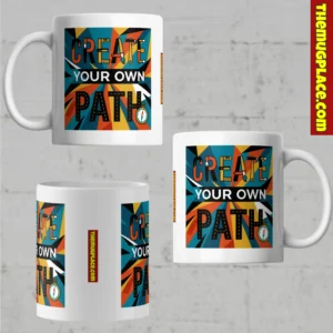 Inspirational mug with colourful CREATE YOUR OWN PATH text and compass, shown from three angles on a grey background.